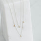 double silver rolo chain with four lab grown round brilliant set in yellow gold bezels.