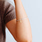 Thick silver bangle with gold dangling heart charm 