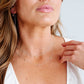 Close-up of a woman wearing a delicate necklace with a blurred background