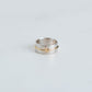 wider sterling silver band with yellow gold wire and a tiny heart.