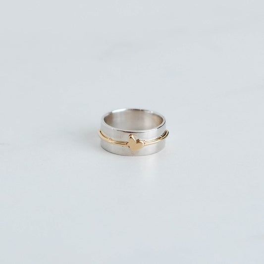 wider sterling silver band with yellow gold wire and a tiny heart.