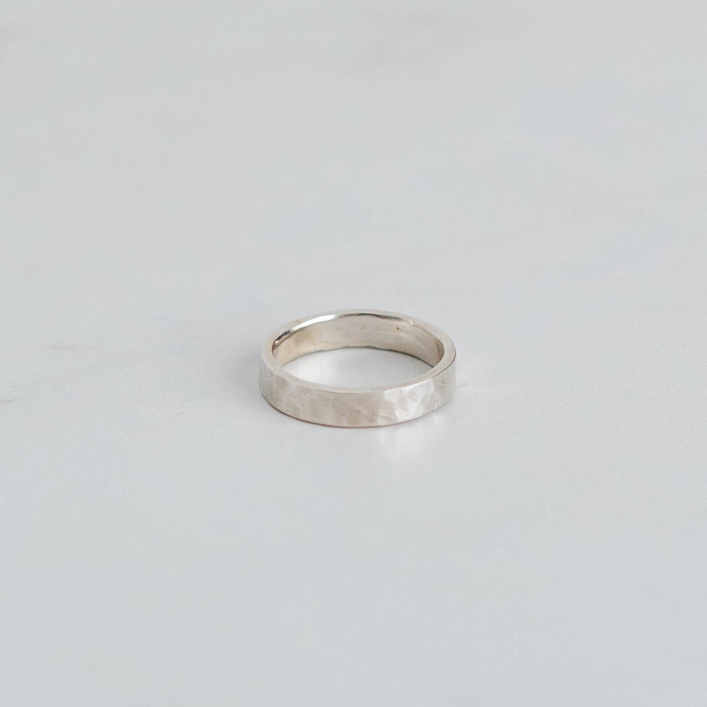 Silver stacking band with a hammered finish