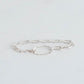 Handmade silver paperclip chain with an oval hammered centre piece. Linked together with a silver trigger clasp.