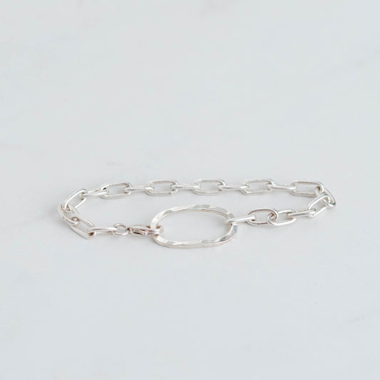 Handmade silver paperclip chain with an oval hammered centre piece. Linked together with a silver trigger clasp.