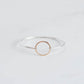 High polished silver bangle with a yellow gold ring connecting it. 