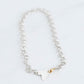 handmade silver chain with a hammered heart pendant and a 10K yellow gold trigger clasp. 